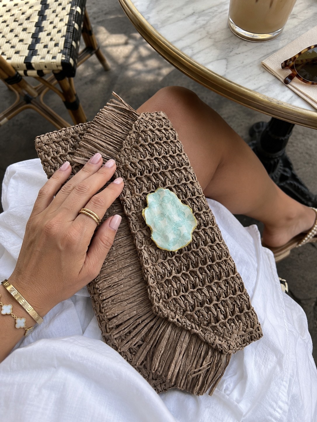 A seafoam-patterned oyster shell accent on a woven bag